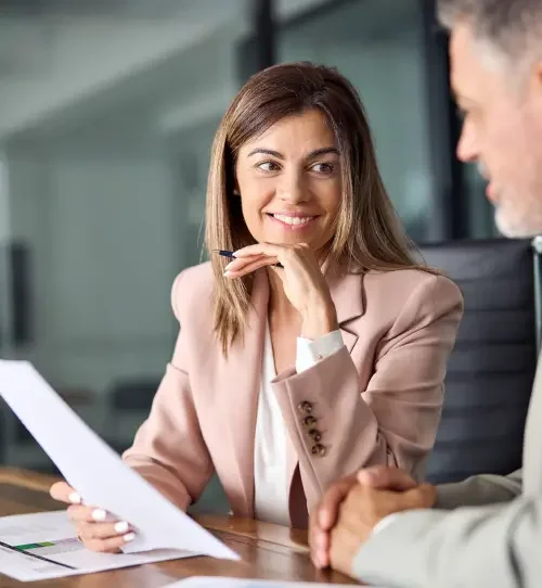 A contract lawyer sitting in an office chair and smiling