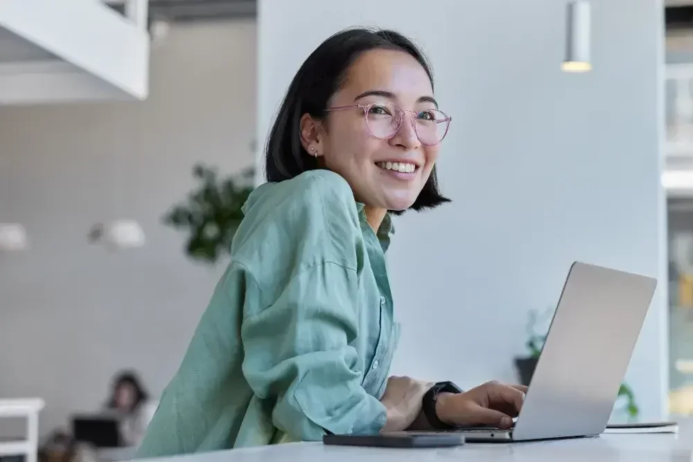 A woman smiles as she looks up how to form an LLC in New York.