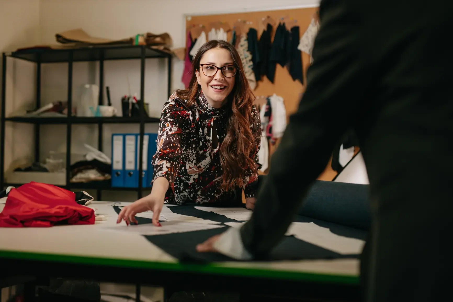 A small business owner tells one of her employees about patenting a new type of fabric.