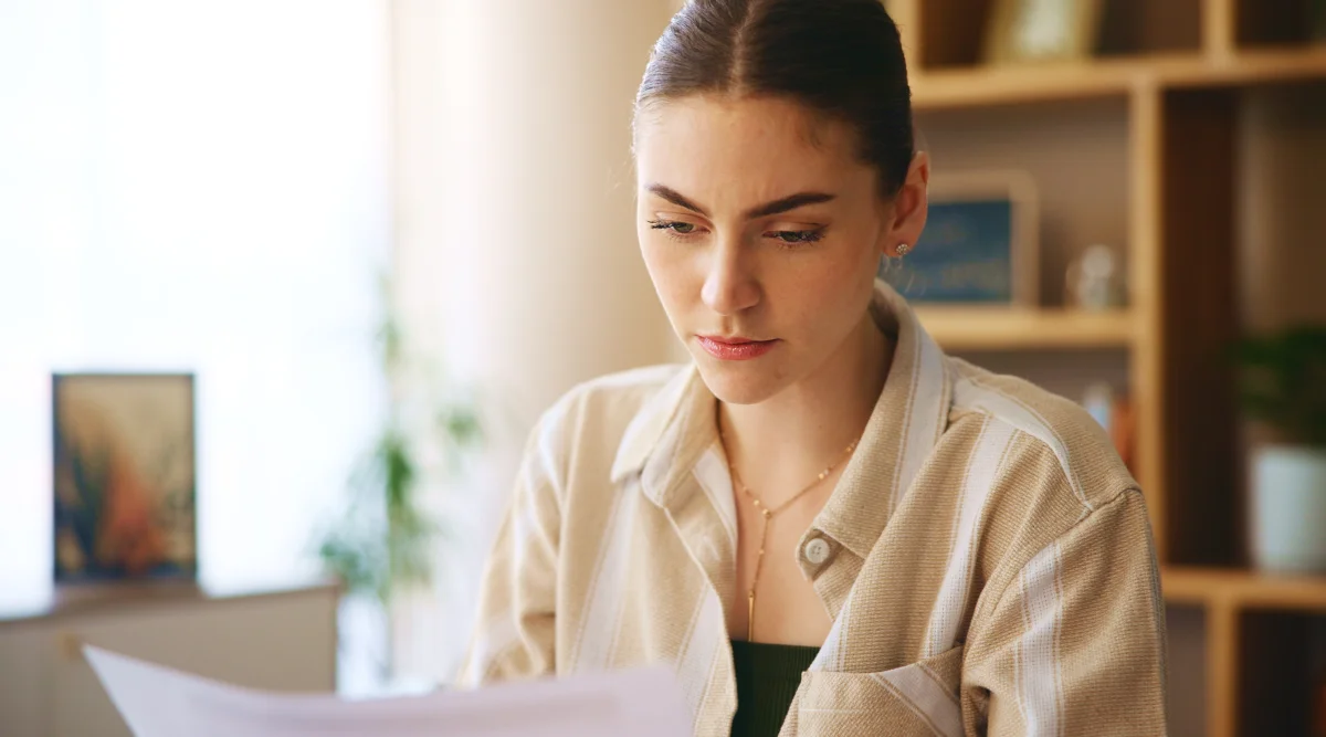 A woman with a slicked back ponytail explore how to make an invoice with a LegalZoom template.