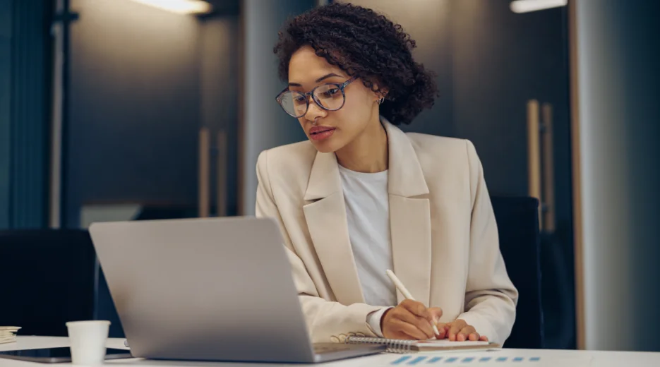 Professional woman works on her computer in upscale office. 