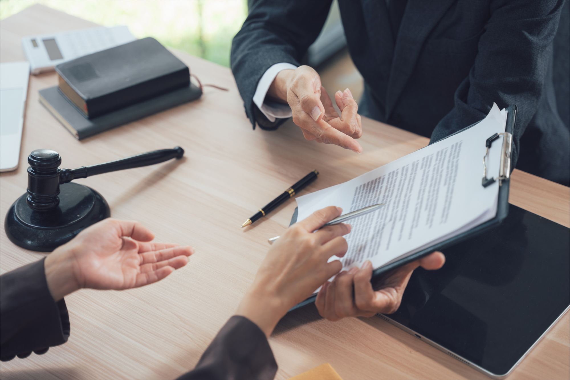 A man explaining the tax obligations of a trustor and trustee from the trust document with a gavel on the desk.