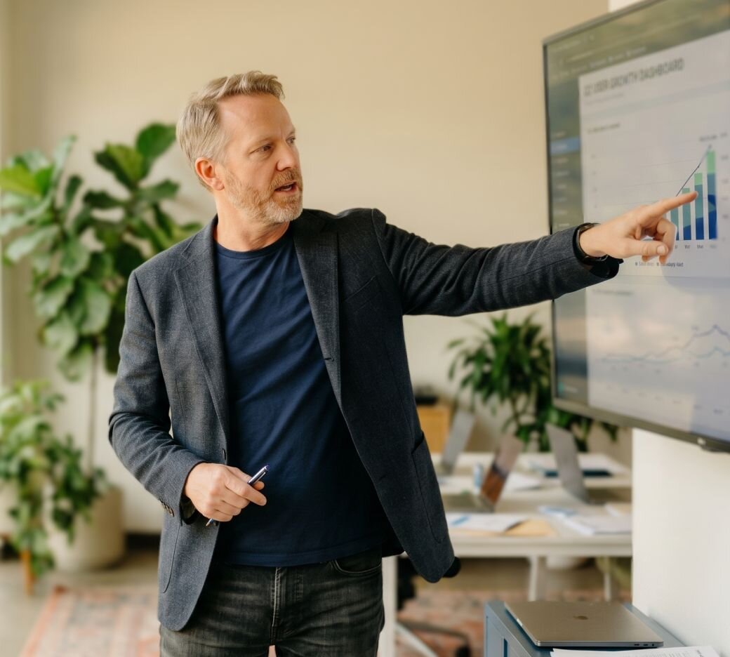 Gray-haired man giving a presentation