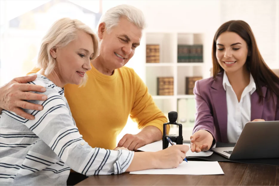 A couple signing a document to open a trust fund account.