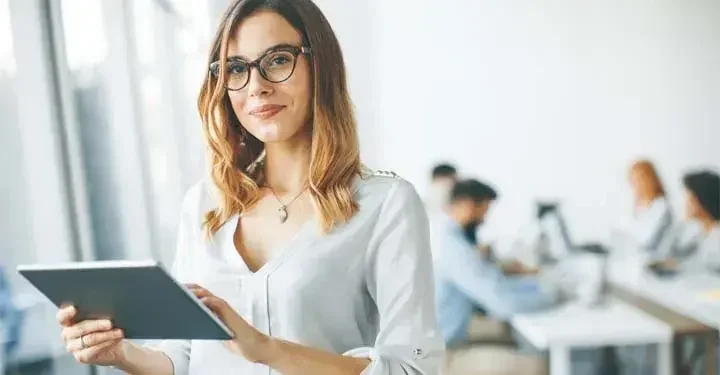 Woman reviewing documents looking at a laptop