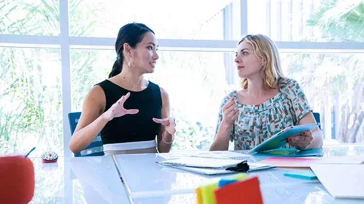 Two women talking business plans