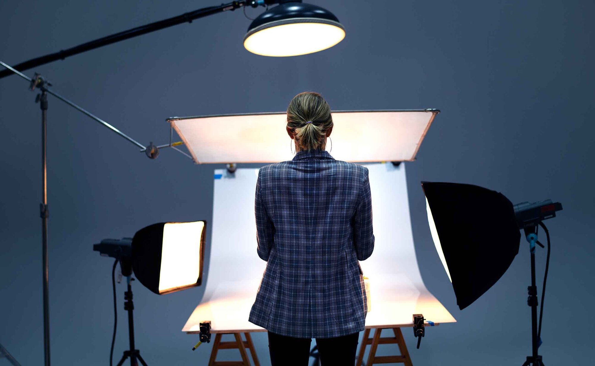 An image of a lady standing in a studio setup.