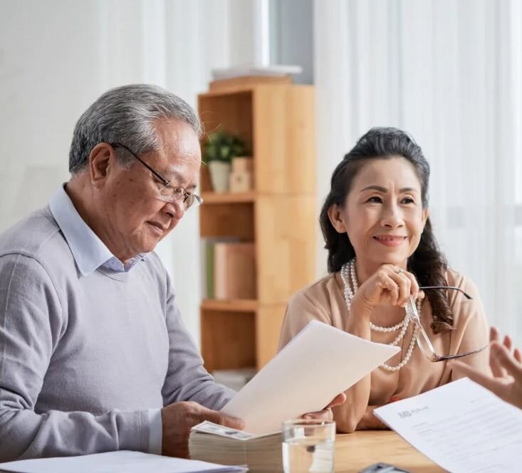 An older couple reviewing documents in an attorney's office
