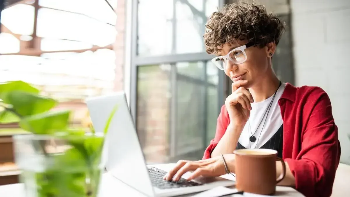 A woman sits at her desk and completes a trademark application.