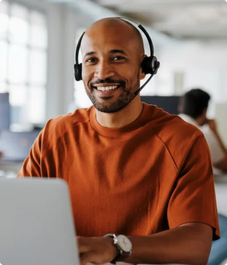 African American man answers calls on his headphones
