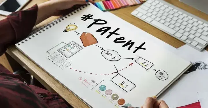 A notebook is open to a page that says "#Patent" in large letters, with illustrations beneath it.