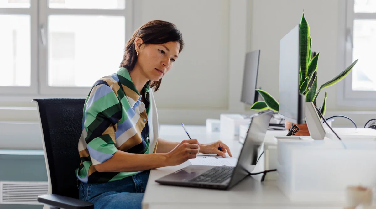A woman working on her laptop.