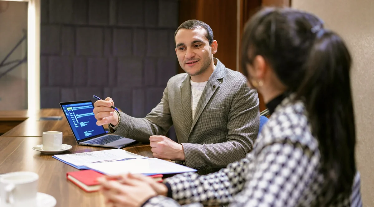 Man in suit discussing work with a colleague