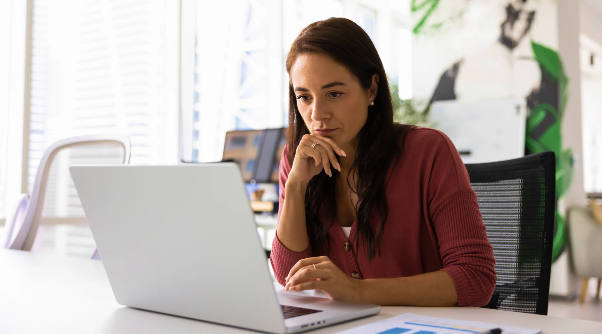 A woman is learning about trustee responsibilities on her laptop.