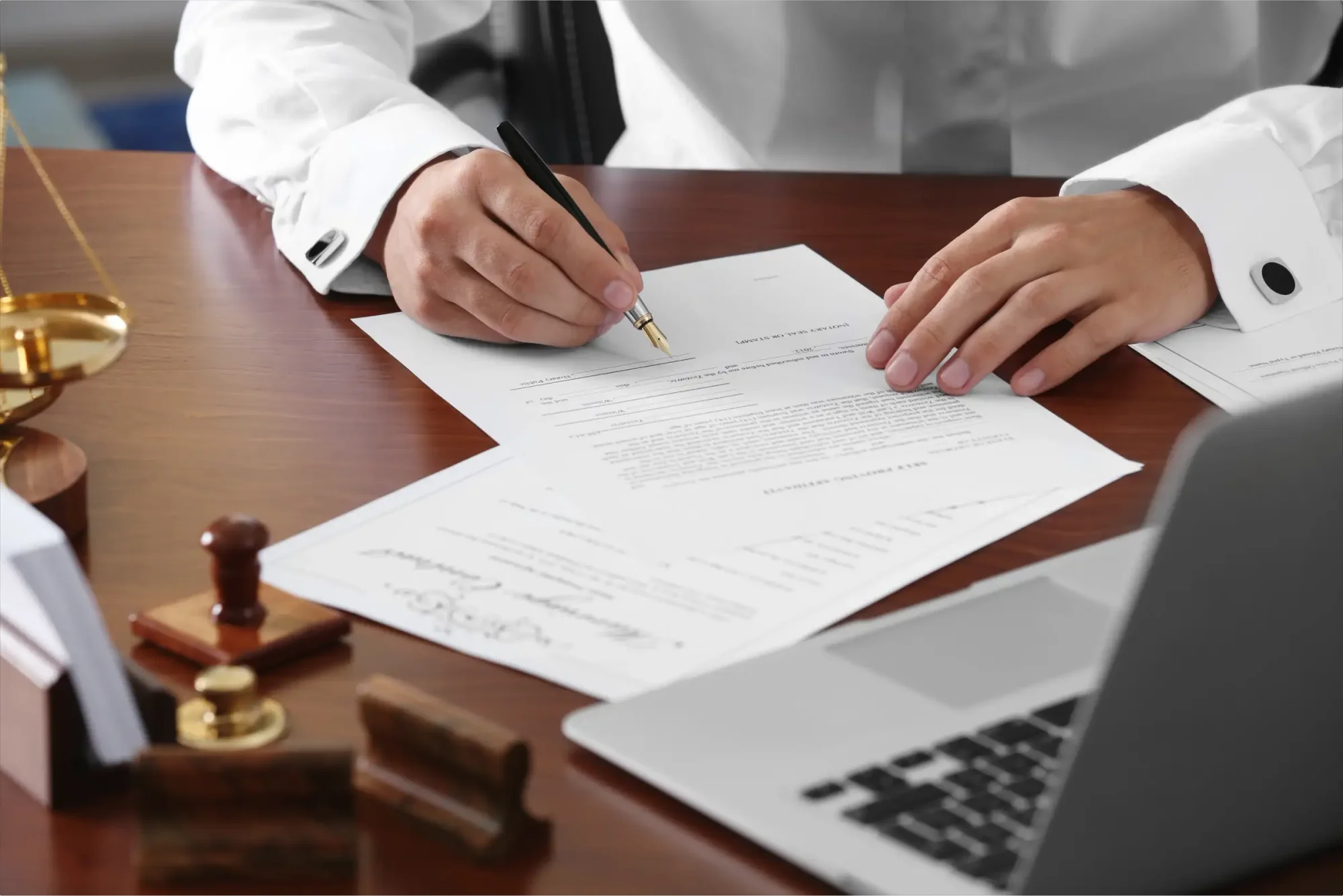 A business professional wearing white business attire checks the changes in his will after revoking the previous will and signing the new, modified will.