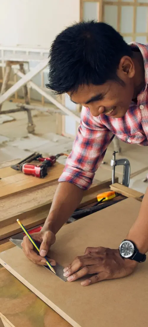 A man woodworking in a workshop