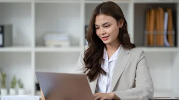 Woman working on a laptop in a professional office