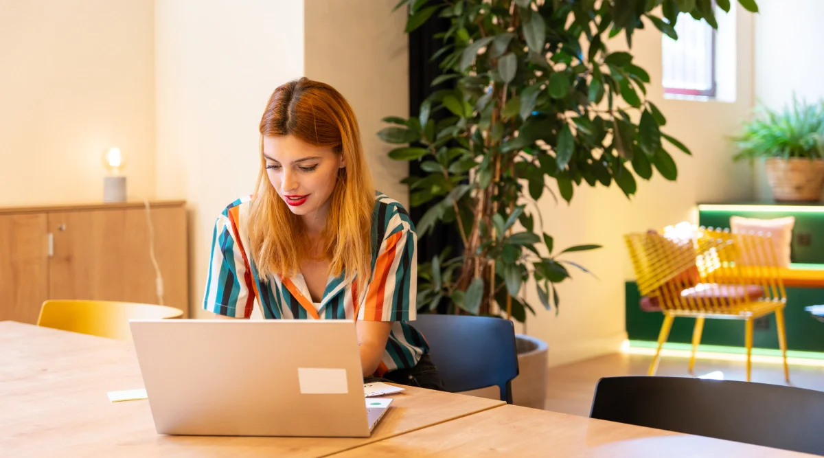 Woman with laptop in colorful room