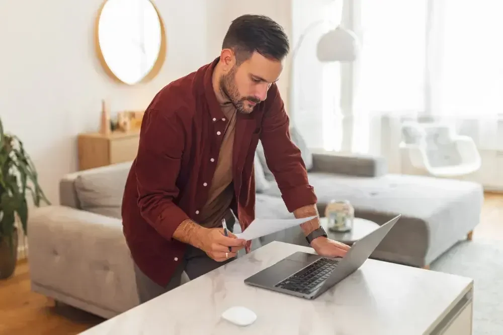 A man searches on his computer for his local vital records office. If the funeral home director or medical examiner cannot provide you with a certified copy of the decedent's death certificate, you should turn to the county or state vital records office where the decedent died.