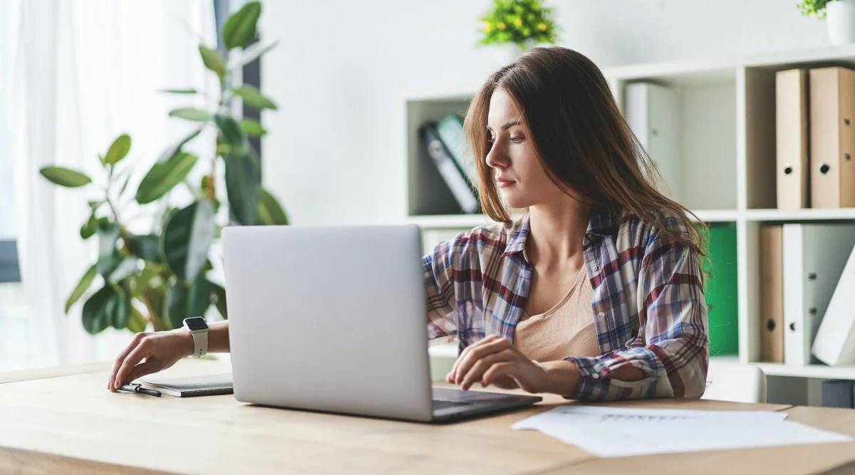 A woman working at a desk.