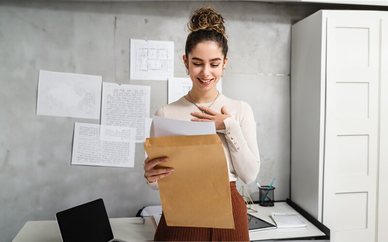 An image of a job applicant happy to see the employment offer letter.