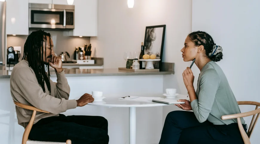 A man and woman sit at a table and contemplate divorce