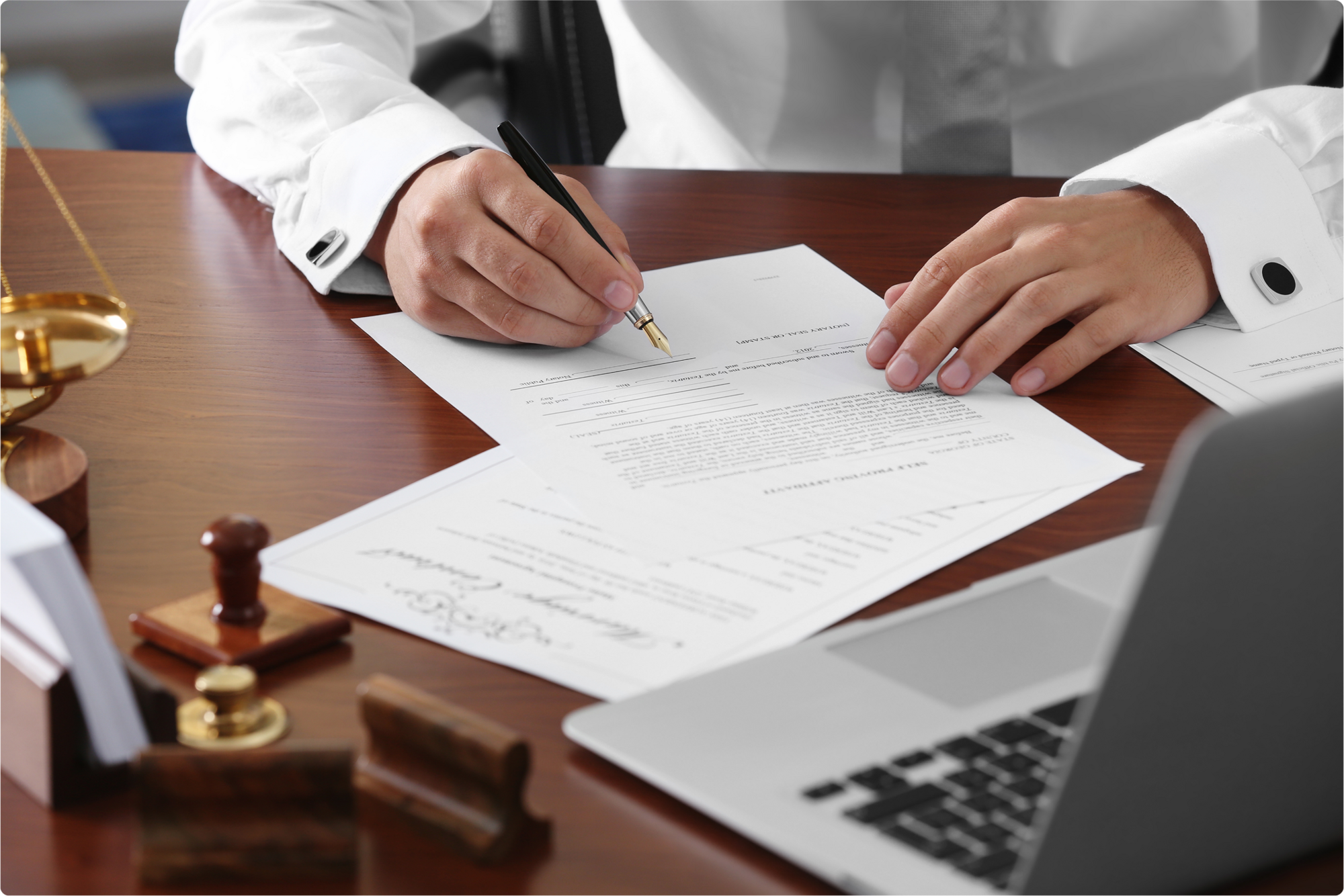 A business professional wearing white business attire checks the changes in his will after revoking the previous will and signing the new, modified will.