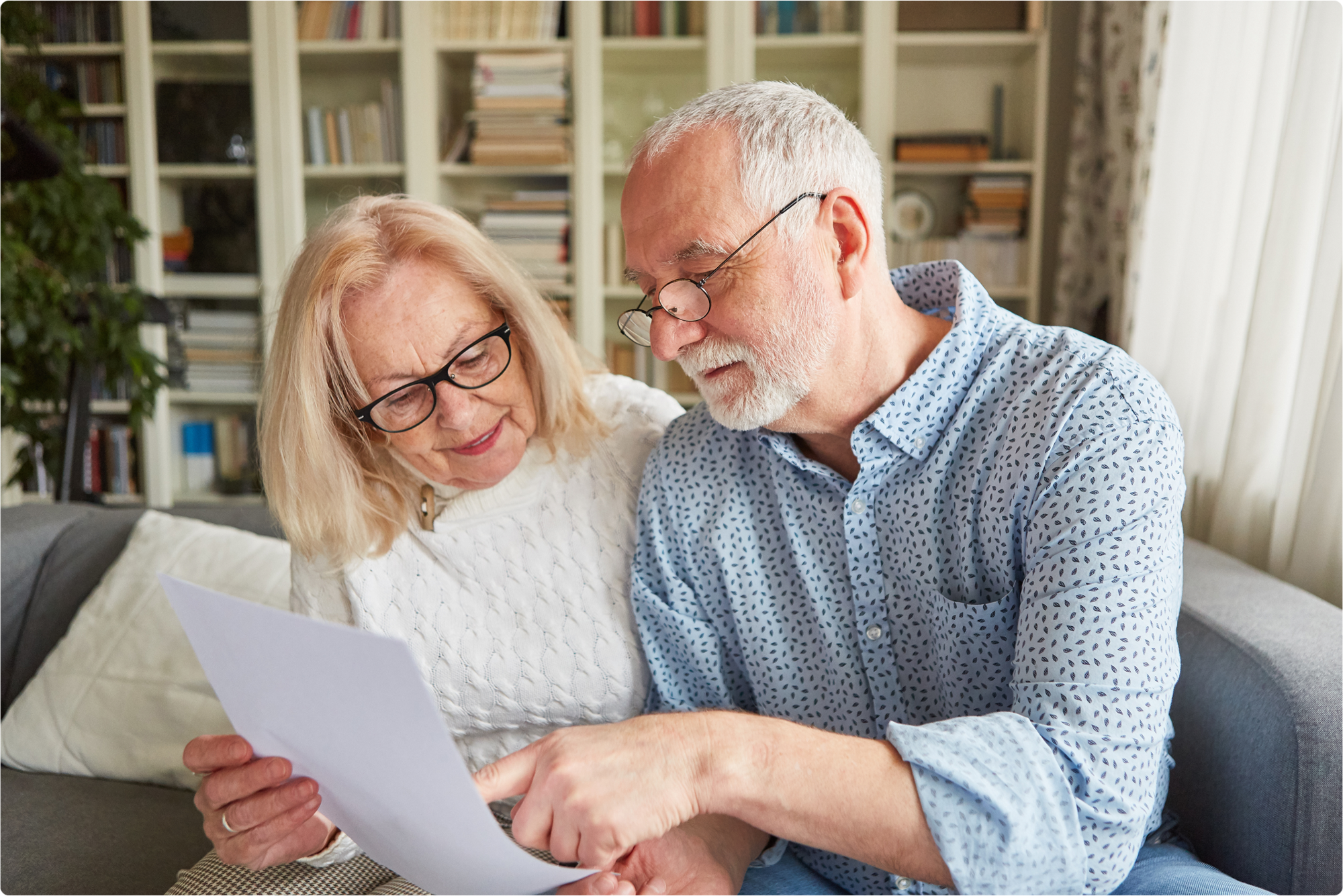 An elderly couple is checking their will before finalizing and signing. Once the person who writes the will dies, their will must be filed with the appropriate Florida probate court to make it recordable and enforceable.