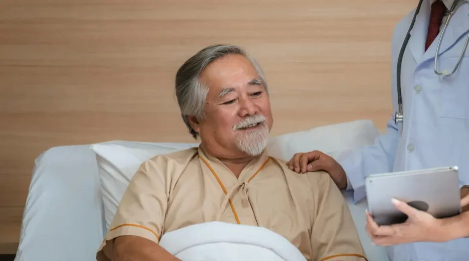 An elderly man admitted to a hospital is having a conversation with a nurse about a power of attorney in Florida.