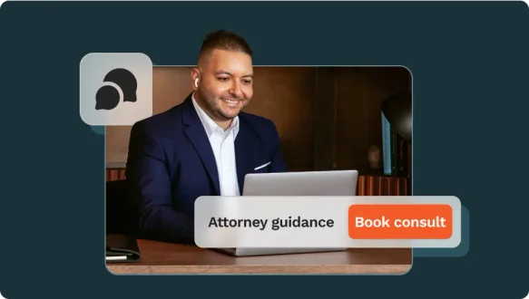 Man with brown hair works on his laptop