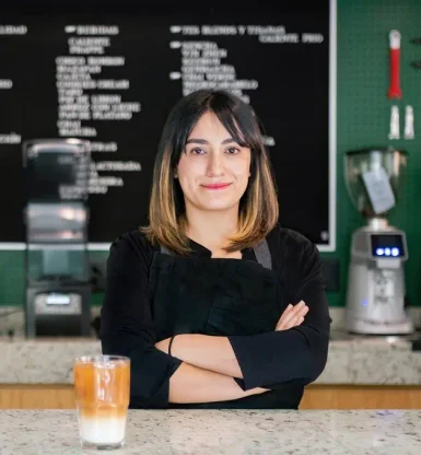 Coffee shop owner standing behind a counter