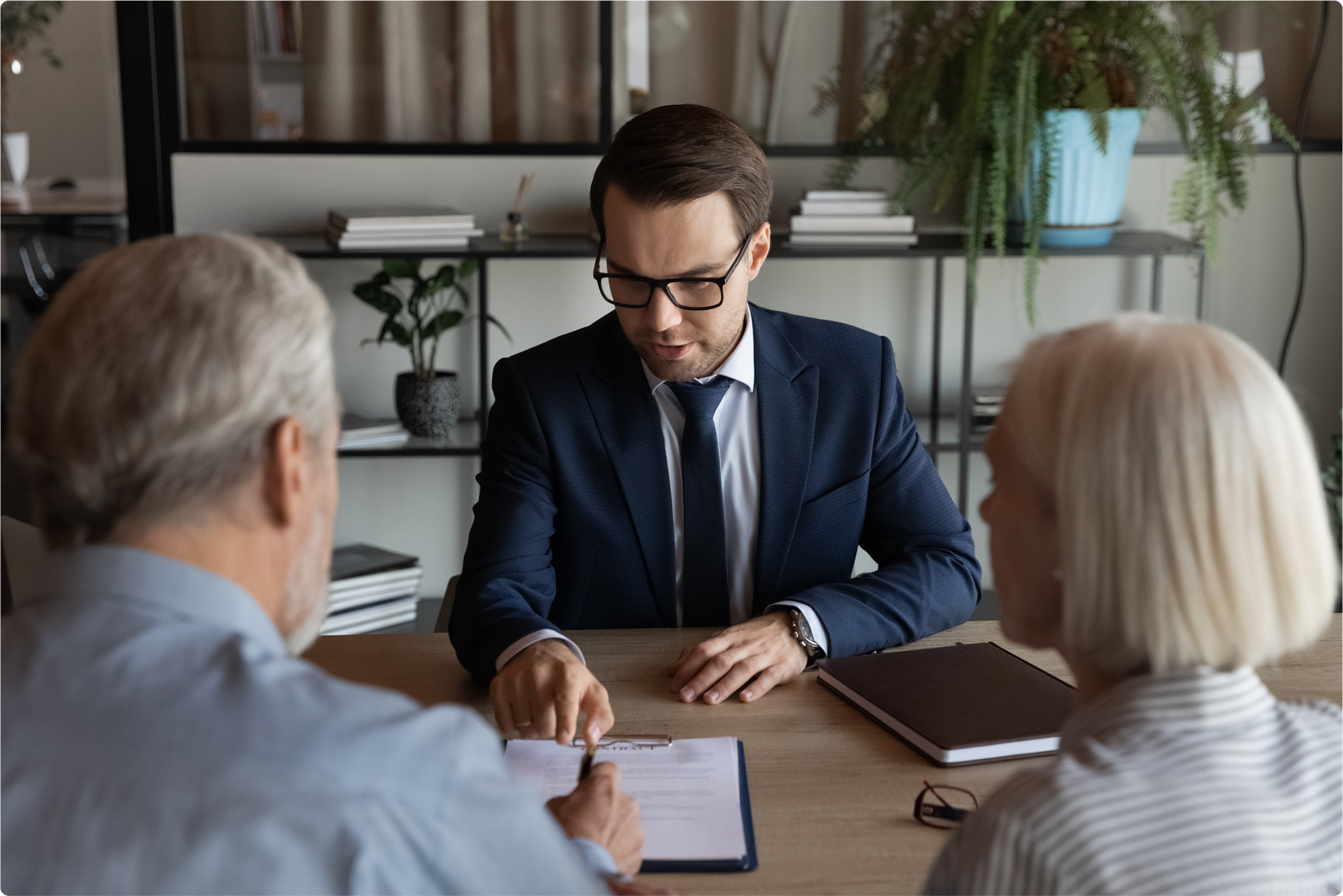 An estate planning attorney guides an elderly couple about the process of writing and creating a valid will in Florida. 