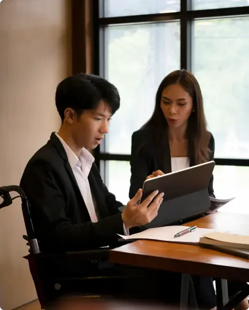 A commercial real estate attorney sitting at a table with a client ensuring the lessee and landlord's responsibilities are clearly outlined in the lease agreement