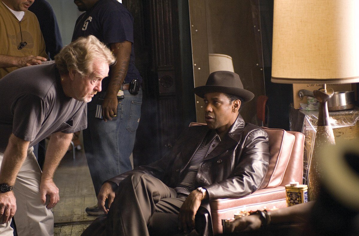 Professional behind the scenes still of director Ridley Scott directing actor Denzel Washington in a scene from the movie American Gangster.