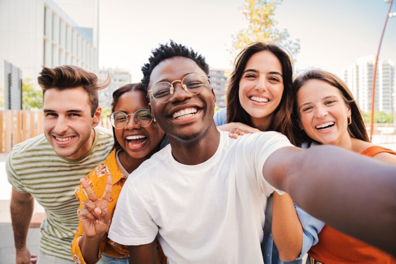 A group of college students are taking a selfie. 