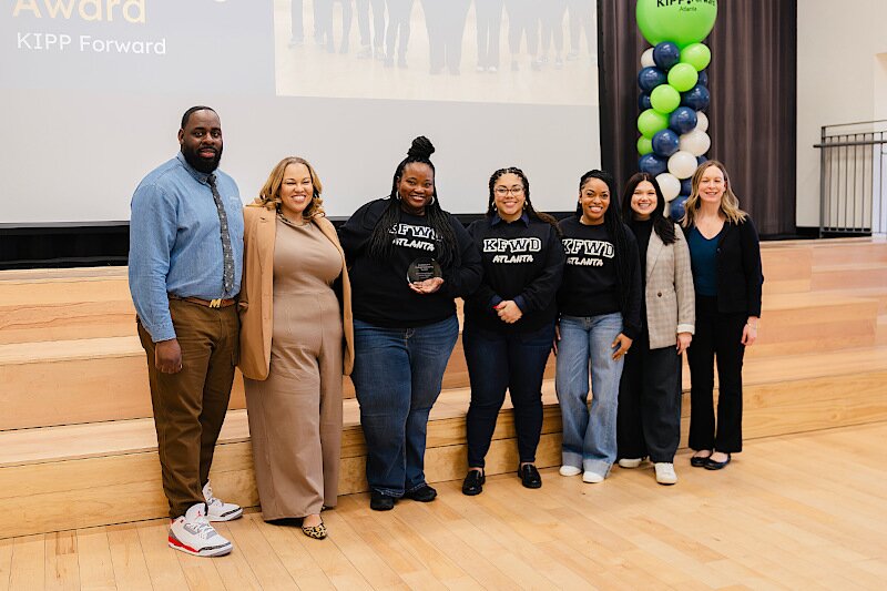 Common App's Stephanie Owens awards the EICC to the KIPP Forward team. 