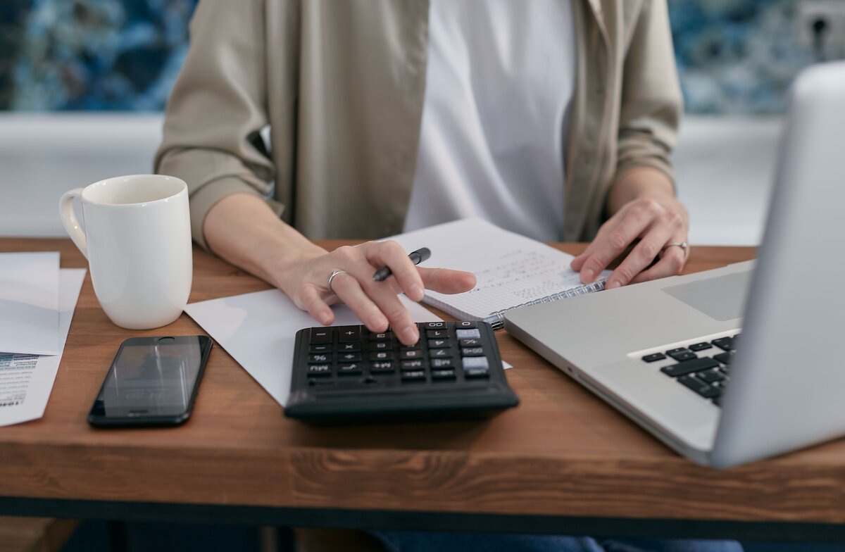 Calculating stamp duty costs using a calculator and laptop