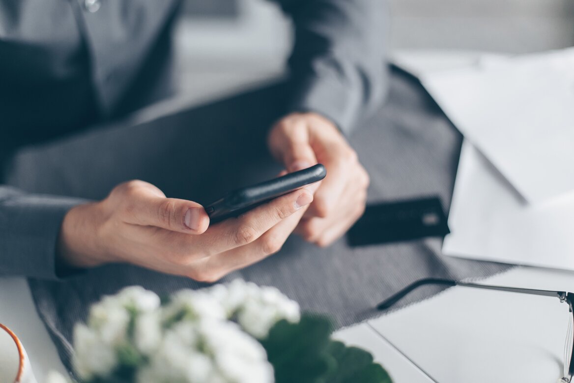 A man using a cellphone to recover account lockout hold