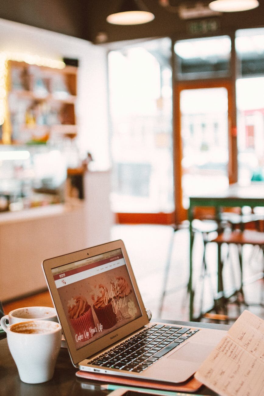 someone on a laptop in a cafe