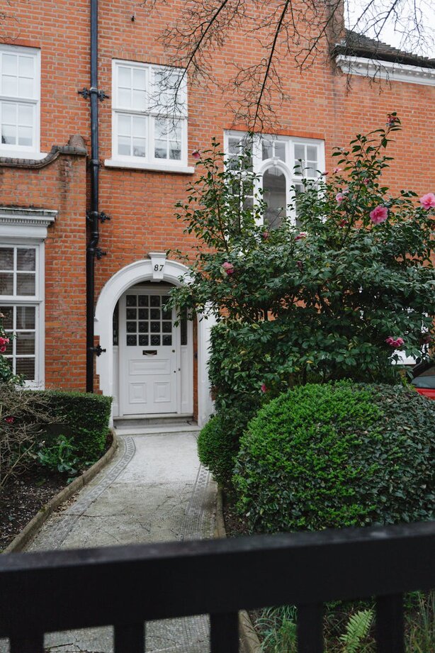 front door of house with bush