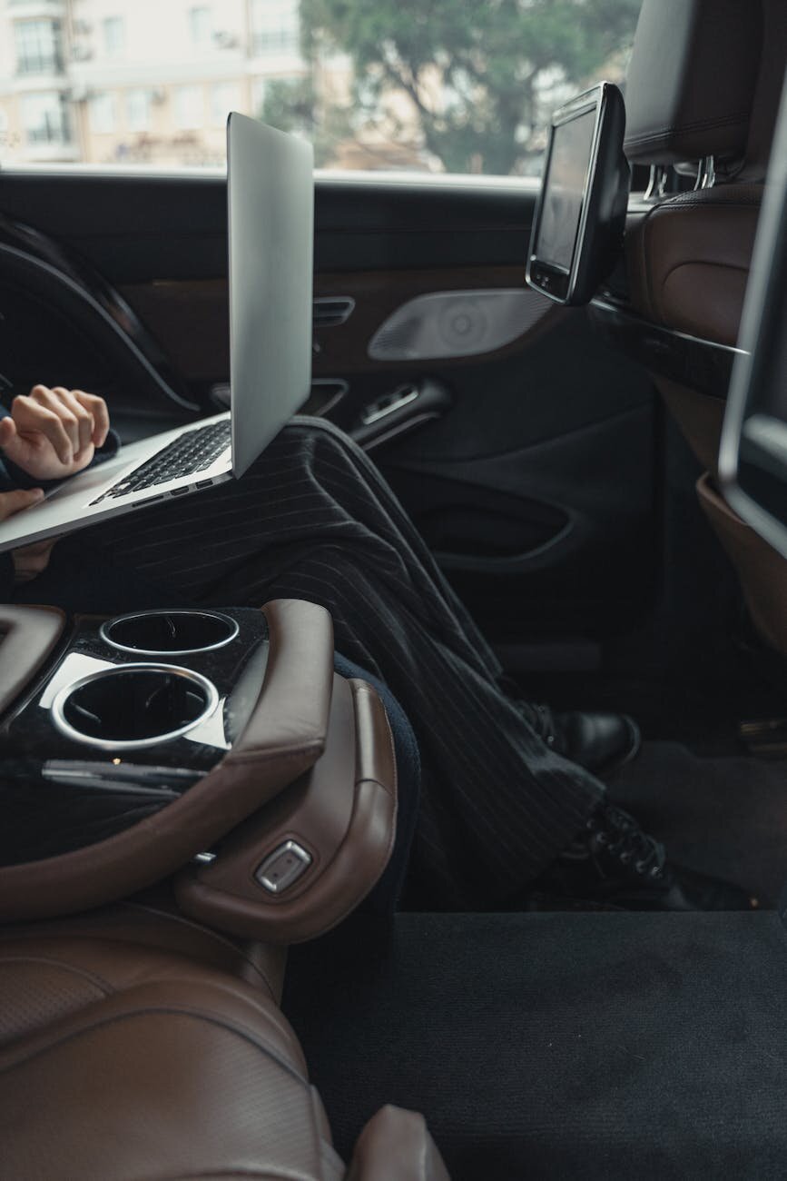 someone on a laptop in a car