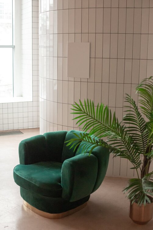 green chair beside plant