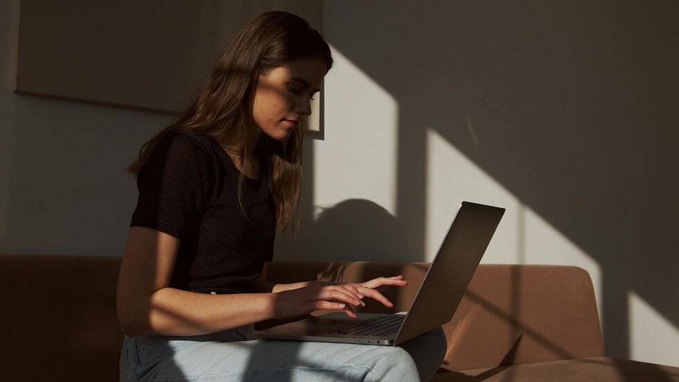 Lady on laptop on couch