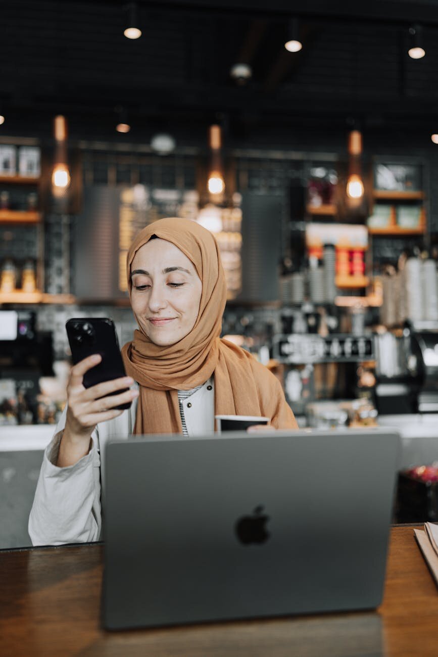lady on a phone and laptop 