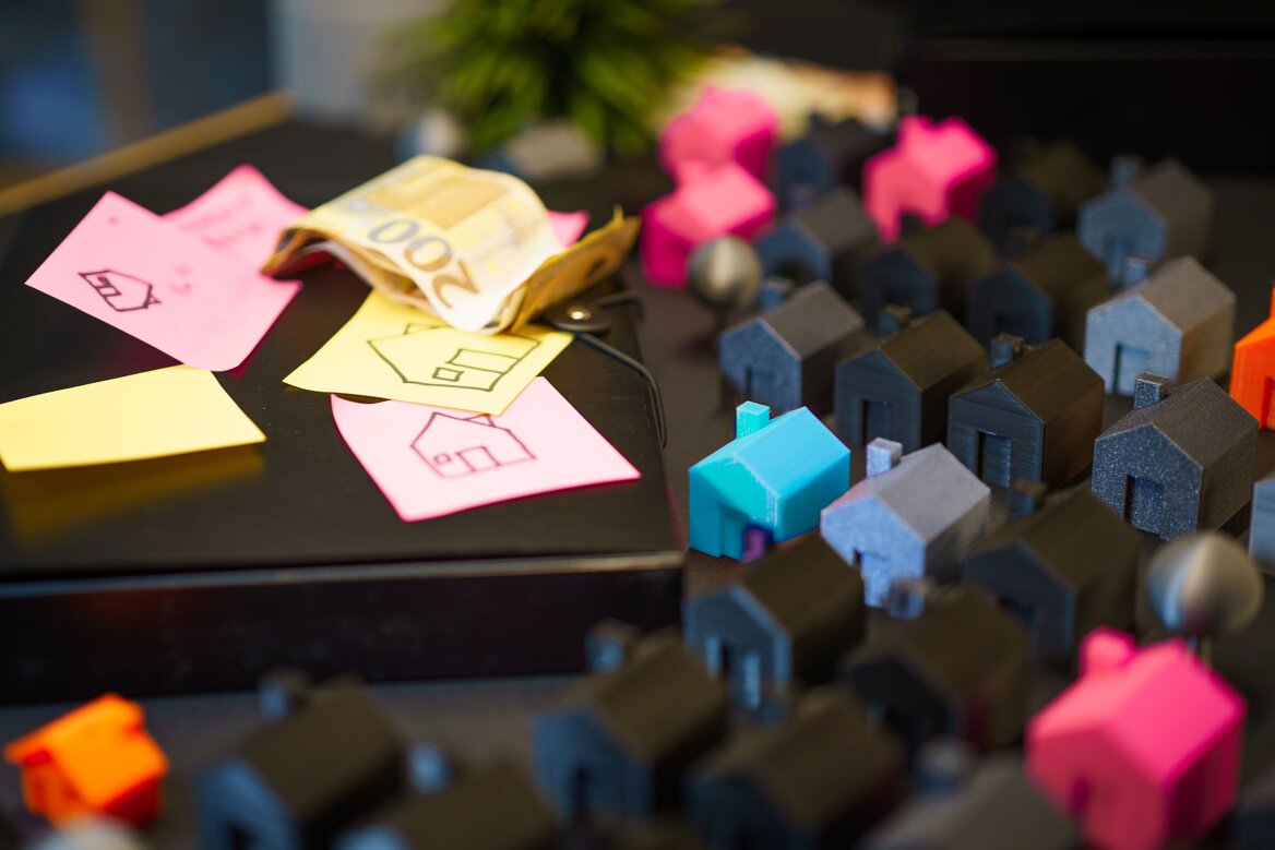 Mini house figures showing property taxation