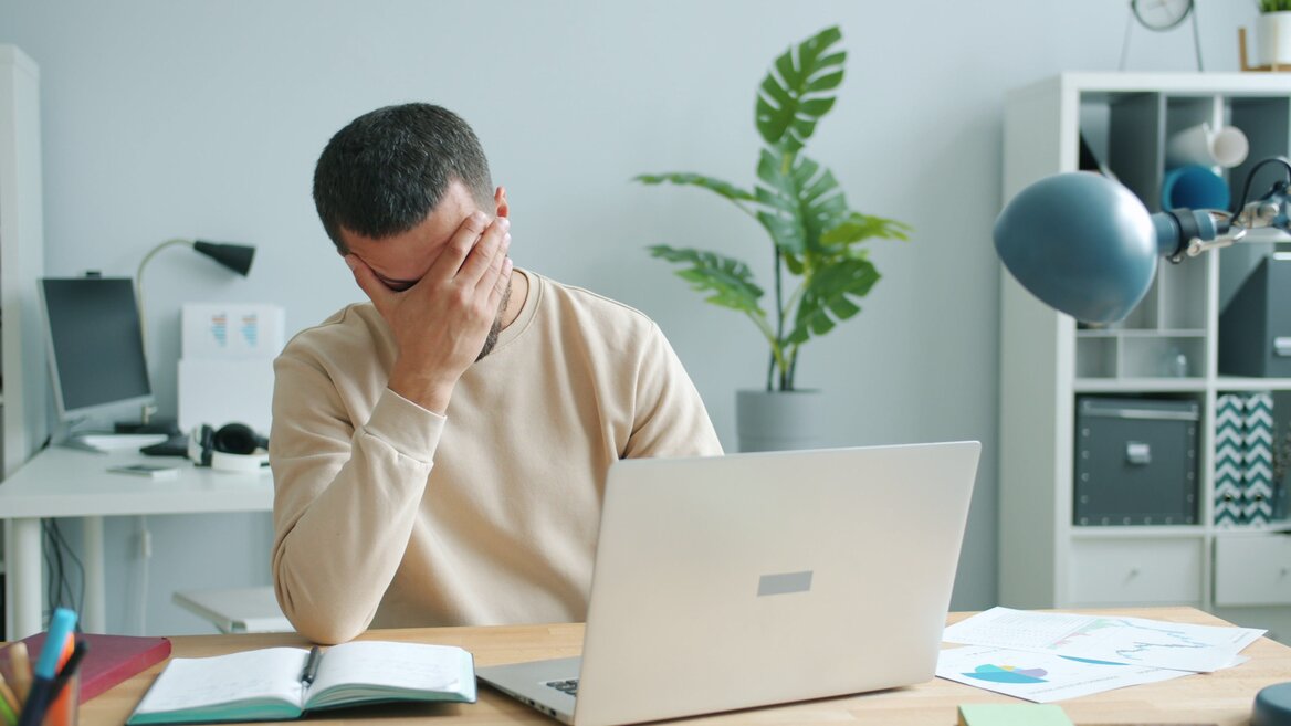 Man stressed from deadlines of tax reporting