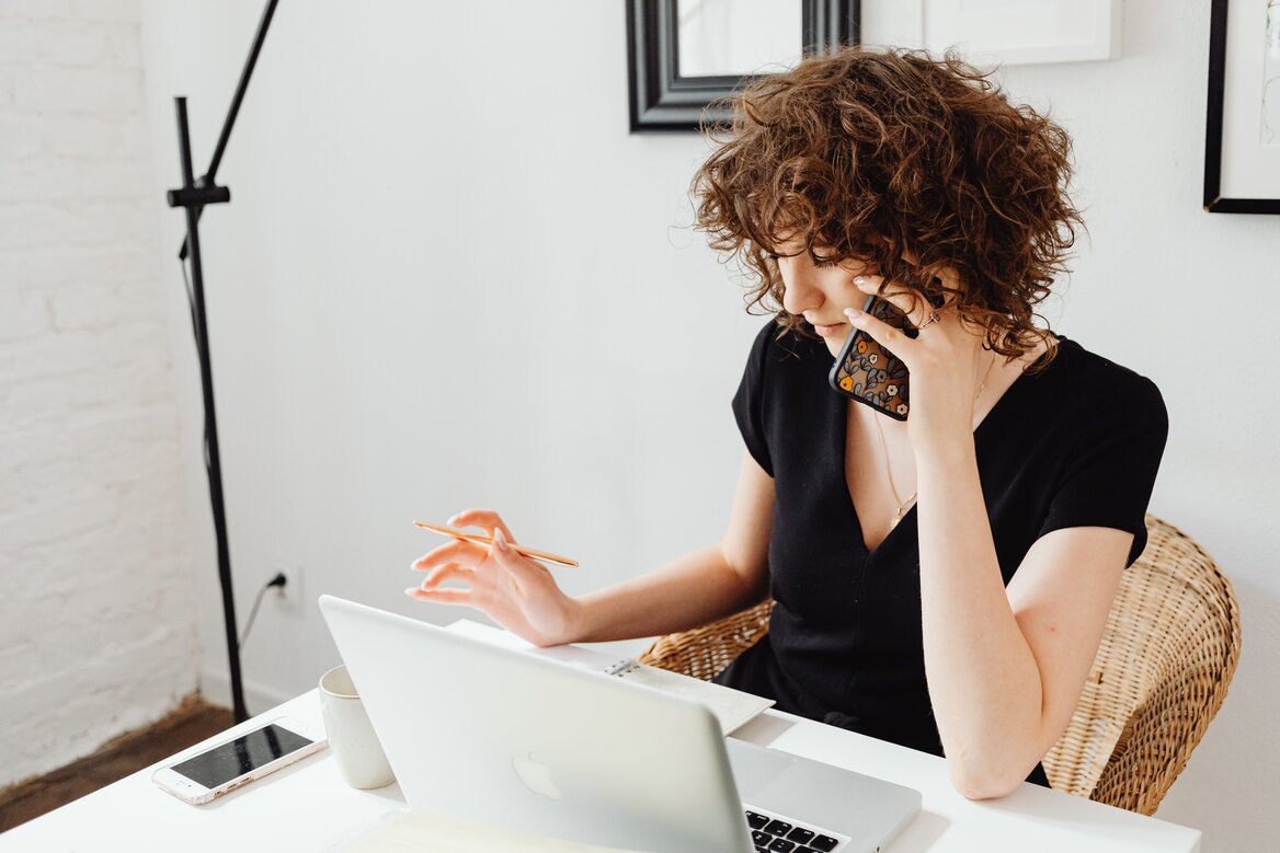Self-employed worker researching self assessment software while on a call