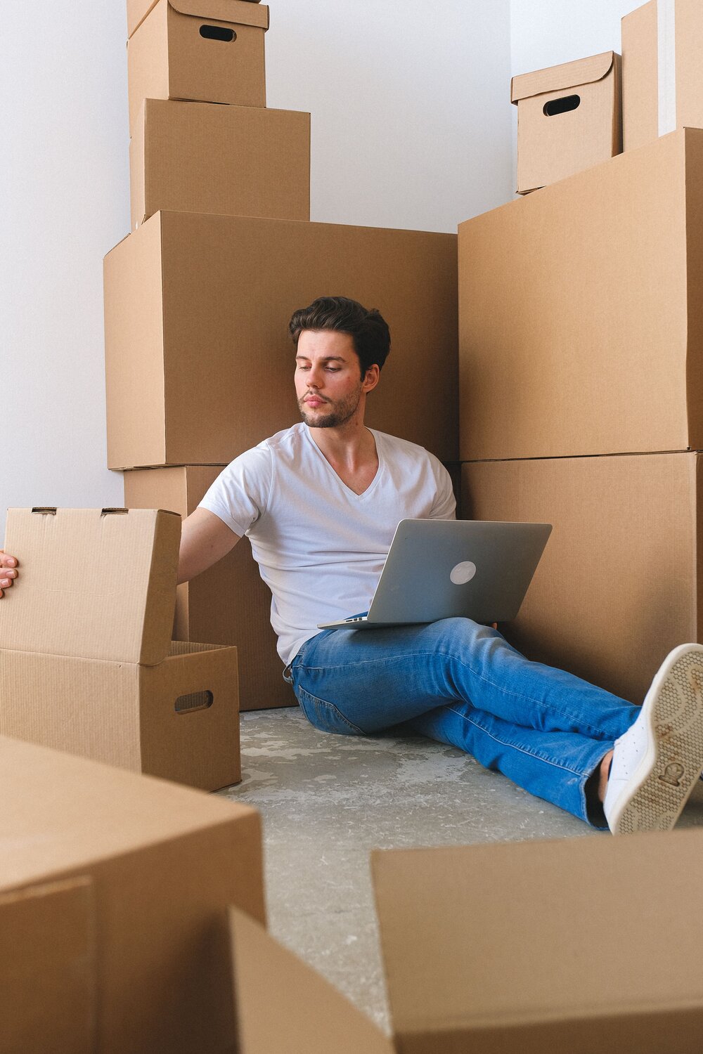 A man opening a packaging while calculating expenditure campaign