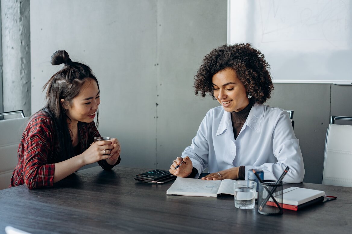 A professional woman discussing digital tax documents during a  meeting
