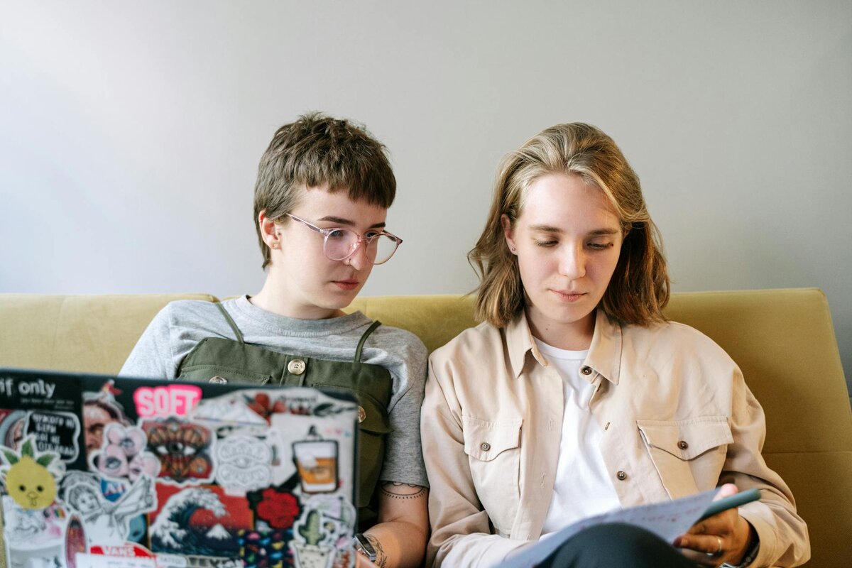 women on laptop in a couch